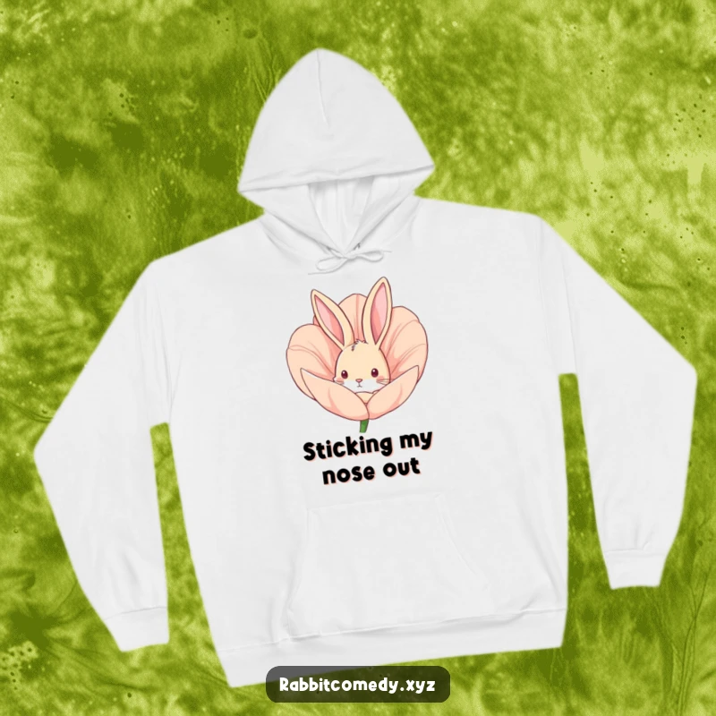 Funny hoodie with a curious rabbit peeking from a large flower bud, offering comfort and a playful woodland vibe.